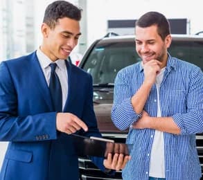 Two mechanics working on a car