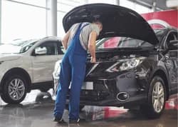 A mechanic inspecting a car